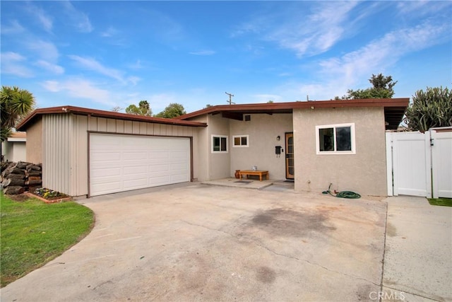 view of front of property with a gate, driveway, and fence