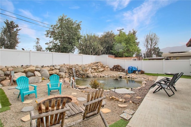 view of patio / terrace featuring an outdoor fire pit and a fenced backyard