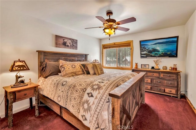 bedroom with baseboards, dark carpet, and a ceiling fan