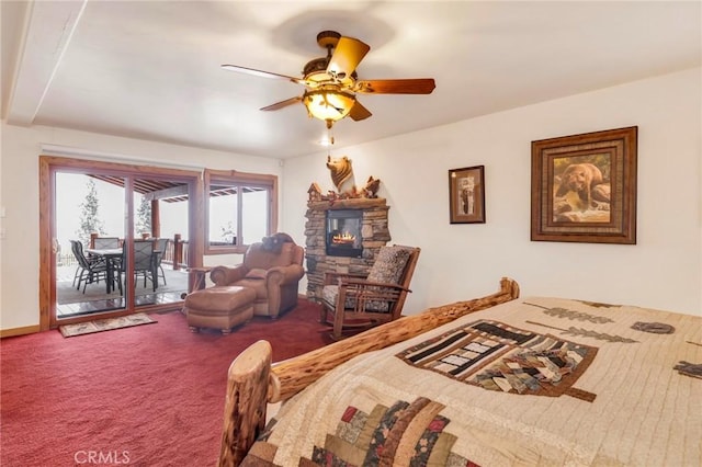 bedroom with access to outside, a fireplace, carpet flooring, and a ceiling fan