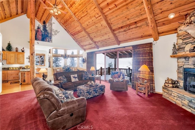 living room featuring high vaulted ceiling, a stone fireplace, beamed ceiling, and wooden ceiling