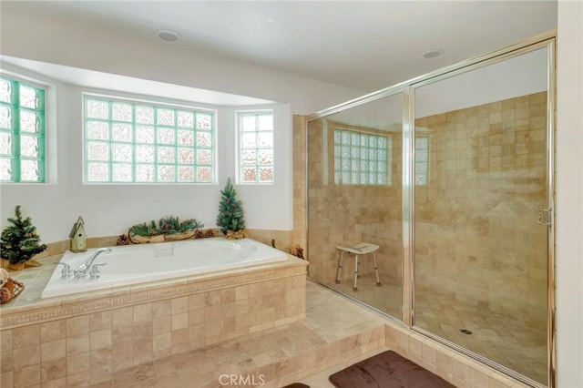 bathroom with a garden tub and a shower stall