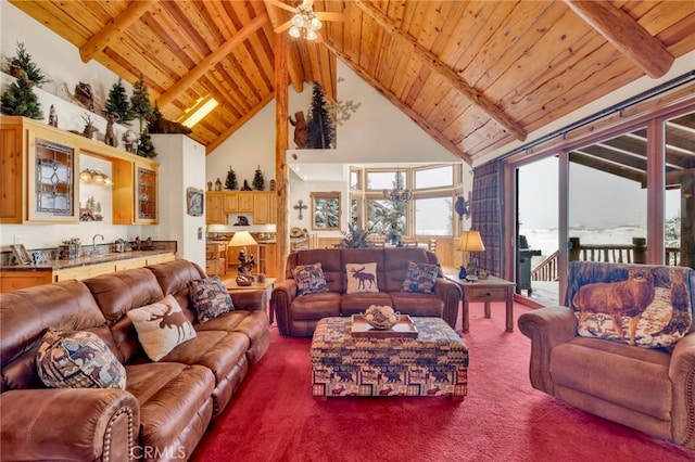 carpeted living room featuring wooden ceiling, ceiling fan, beamed ceiling, high vaulted ceiling, and a sink