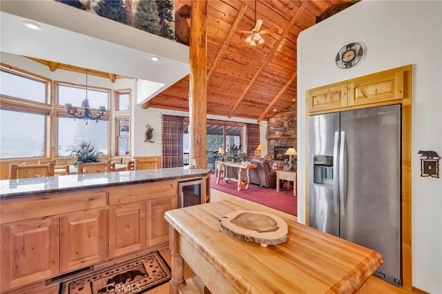 kitchen featuring lofted ceiling with beams, wine cooler, wooden ceiling, a fireplace, and stainless steel fridge with ice dispenser