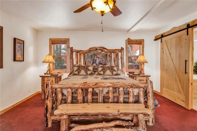 carpeted bedroom featuring a barn door, baseboards, and ceiling fan