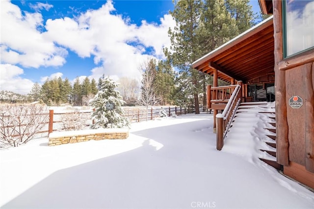 snowy yard with fence and stairway