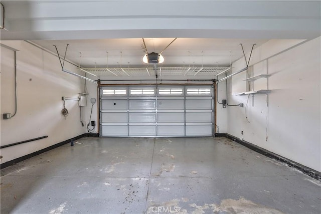 garage with baseboards and a garage door opener