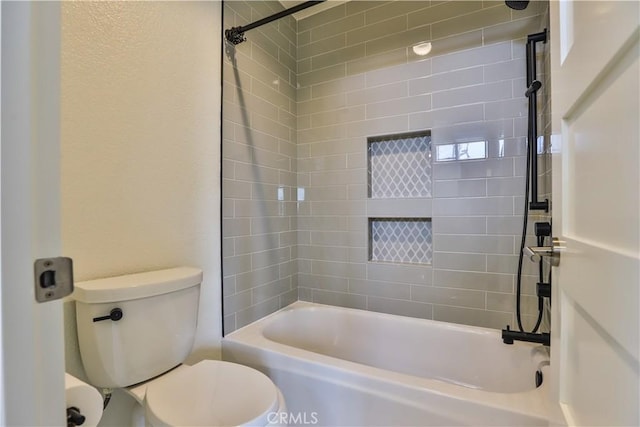 bathroom with toilet and bathing tub / shower combination