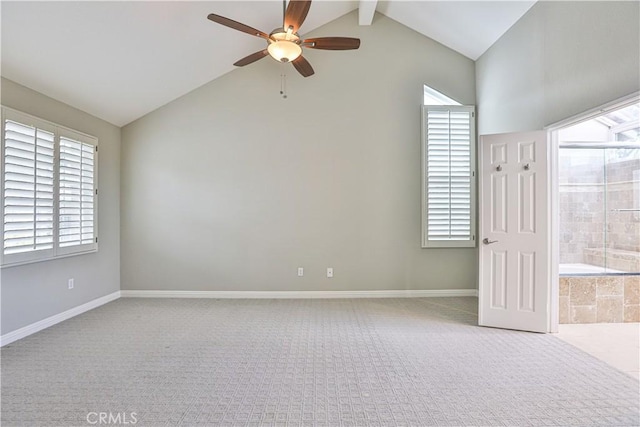 carpeted spare room featuring a ceiling fan, lofted ceiling with beams, and baseboards