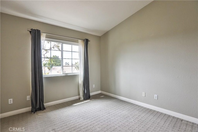 carpeted empty room with baseboards