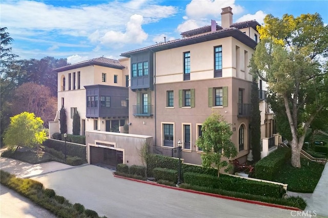 exterior space with a chimney and stucco siding