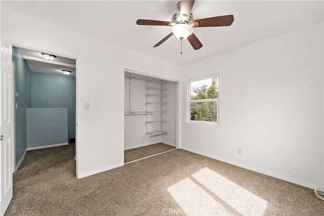 unfurnished bedroom featuring a ceiling fan, carpet, baseboards, and a closet