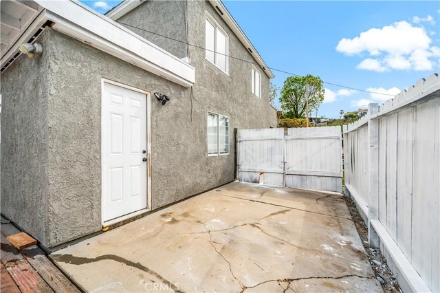 view of patio / terrace with a gate and fence