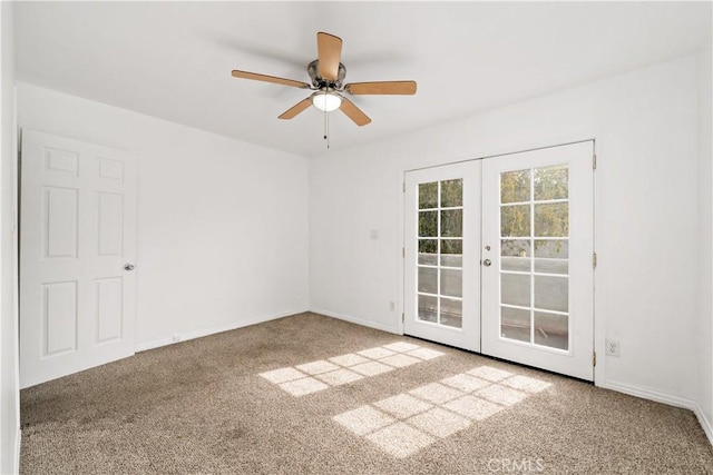 carpeted empty room featuring a ceiling fan, french doors, and baseboards