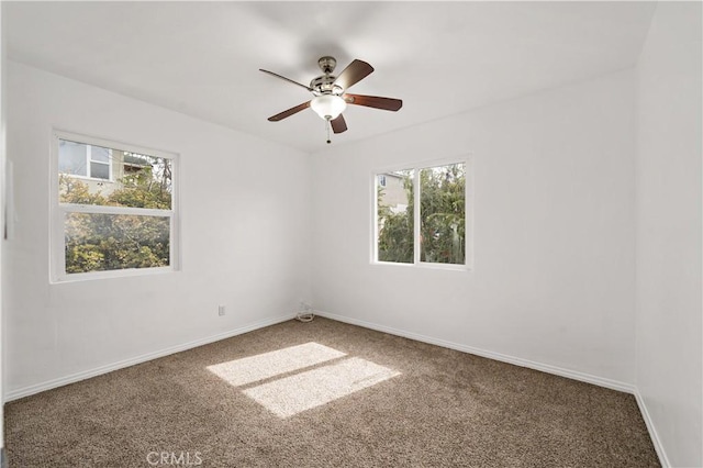 spare room featuring ceiling fan, carpet flooring, and baseboards