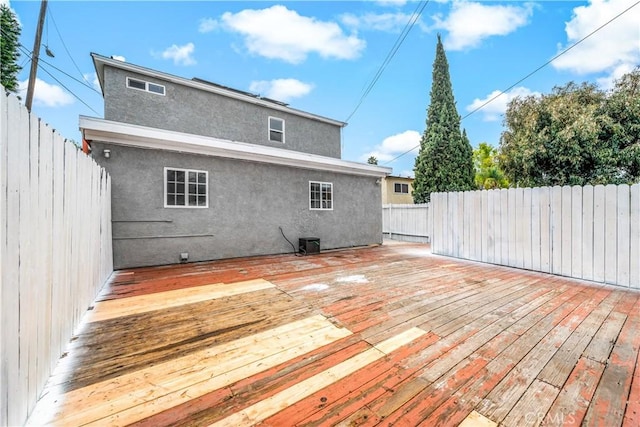 wooden deck featuring a fenced backyard and central AC unit