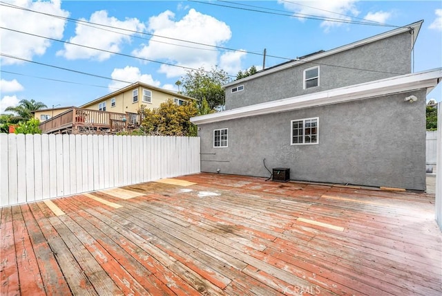 wooden terrace featuring fence