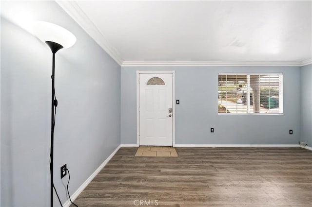 foyer entrance with baseboards, ornamental molding, and wood finished floors