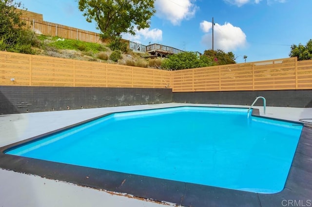 view of swimming pool with a fenced backyard and a fenced in pool