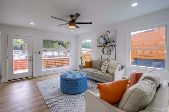 living area featuring a ceiling fan, recessed lighting, and wood finished floors