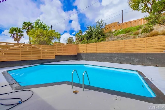 view of swimming pool with a fenced in pool, a patio area, and a fenced backyard