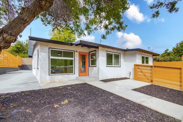 view of front of property featuring fence and stucco siding