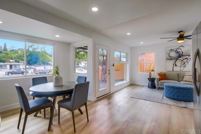 dining room with baseboards, a ceiling fan, light wood-style flooring, and recessed lighting