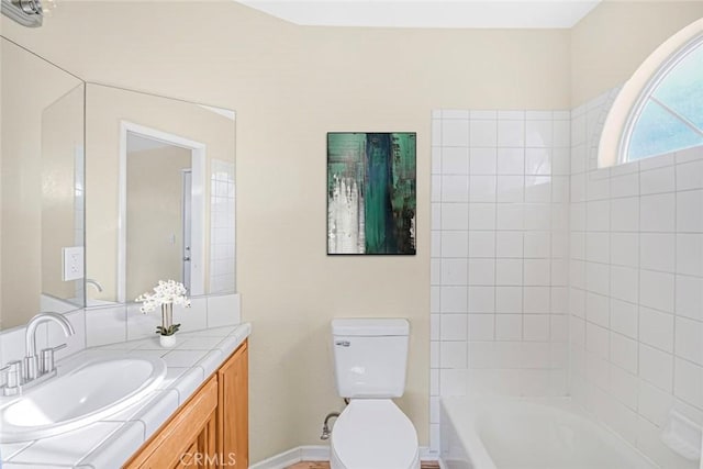 bathroom featuring vanity, shower / bathing tub combination, toilet, and baseboards