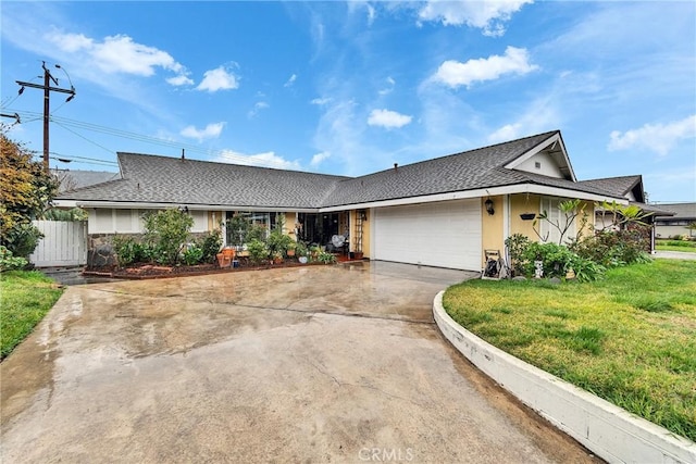 ranch-style house featuring driveway, a garage, fence, a front yard, and stucco siding