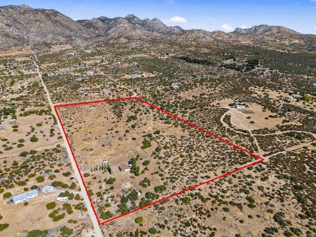 aerial view featuring a rural view, a desert view, and a mountain view