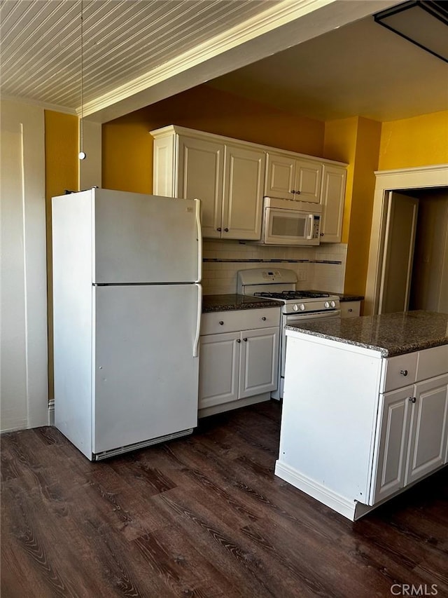 kitchen featuring decorative backsplash, dark stone countertops, white appliances, white cabinetry, and dark wood-style flooring