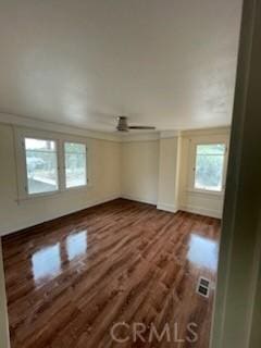 unfurnished room with wood finished floors and visible vents