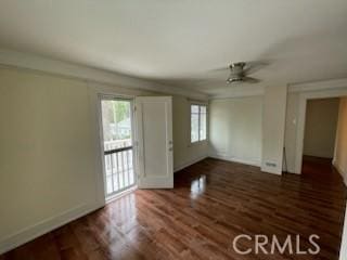 interior space featuring baseboards and wood finished floors