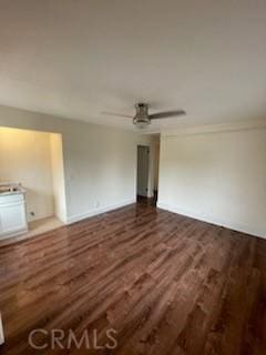 unfurnished room featuring a ceiling fan and dark wood-style flooring