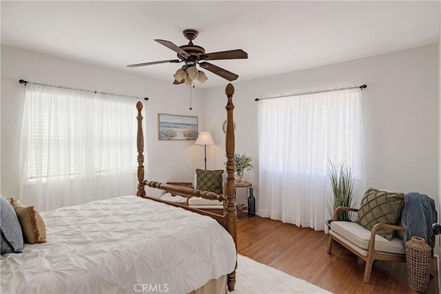 bedroom with a ceiling fan and wood finished floors