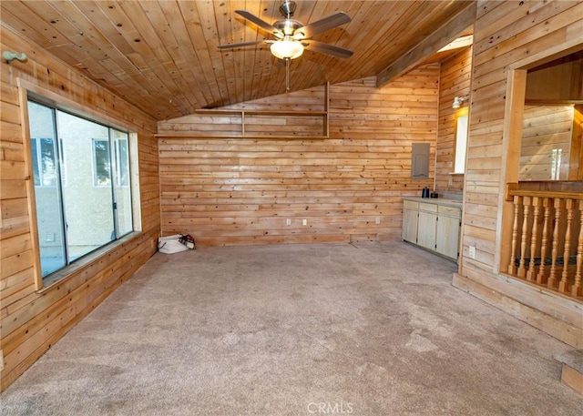 spare room featuring lofted ceiling, wood walls, wooden ceiling, and carpet flooring