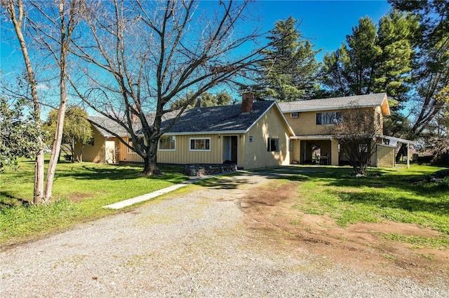 4760 County Rd 99 W, Orland, CA 96963 - view of front of house featuring a chimney, dirt driveway, and a front lawn