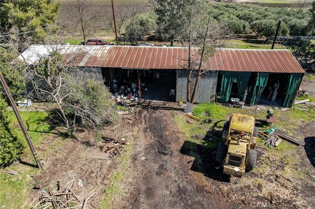 exterior space featuring an outbuilding and metal roof