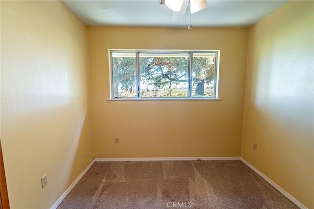 carpeted empty room featuring baseboards