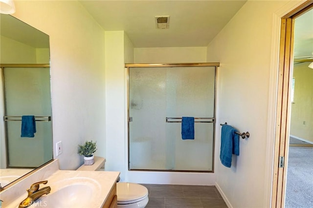 bathroom featuring a stall shower, visible vents, vanity, and toilet