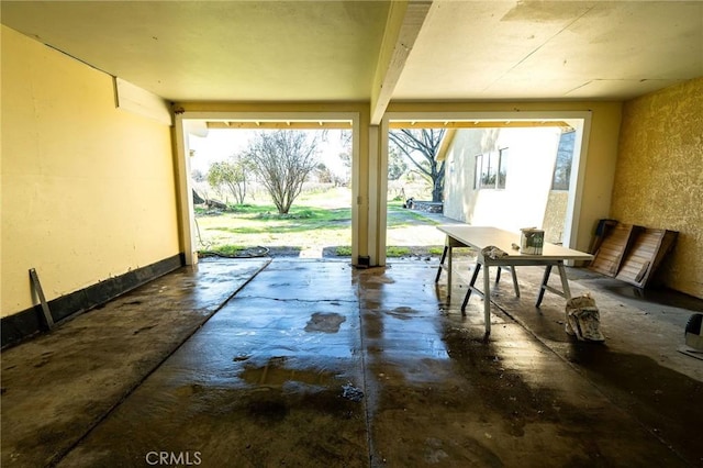 interior space with a textured wall and concrete floors