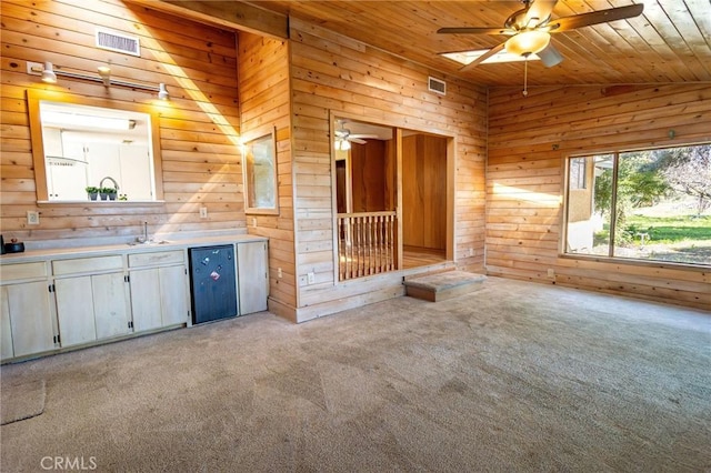 4760 County Rd 99 W, Orland, CA 96963 - unfurnished living room with ceiling fan, light carpet, wood walls, wood ceiling, and a sink