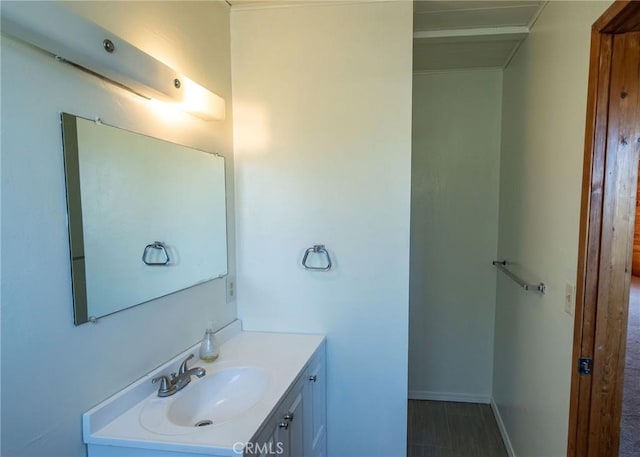 bathroom with baseboards and vanity