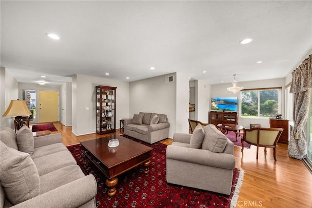 living room featuring recessed lighting, visible vents, and light wood-style floors