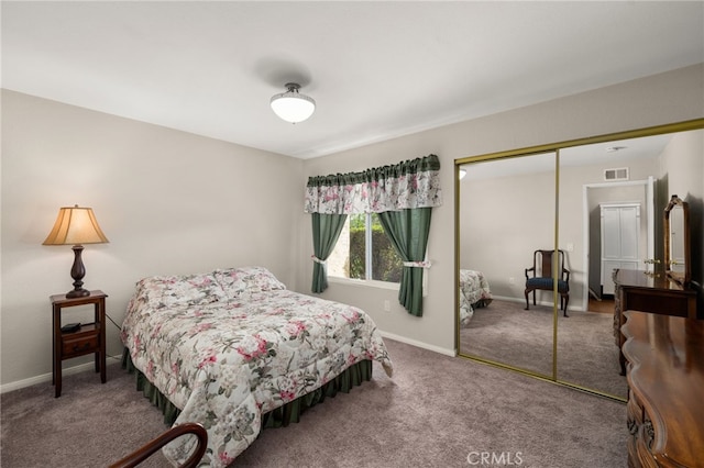 bedroom with baseboards, a closet, carpet floors, and visible vents