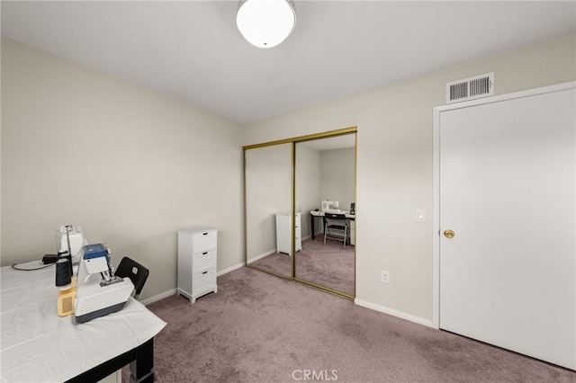 office space with carpet, visible vents, and baseboards