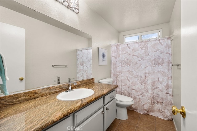 bathroom featuring tile patterned flooring, a shower with shower curtain, toilet, and vanity