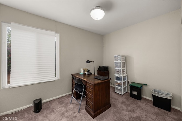 carpeted office space featuring baseboards