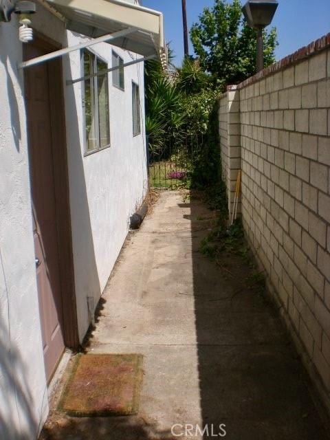 4771 68th St, La Mesa, CA 91942 - view of side of home featuring stucco siding and fence