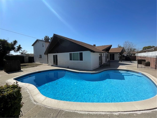 view of swimming pool with a patio area, fence, and a fenced in pool